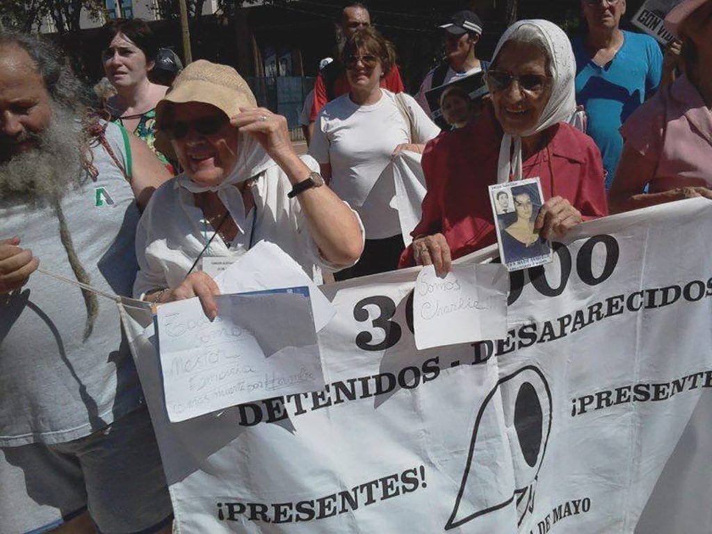 Abuelas de Plaza de Mayo han sido nominadas al Premio Nobel de la Paz en cinco ocasiones. She is seen here speaking at a protest.