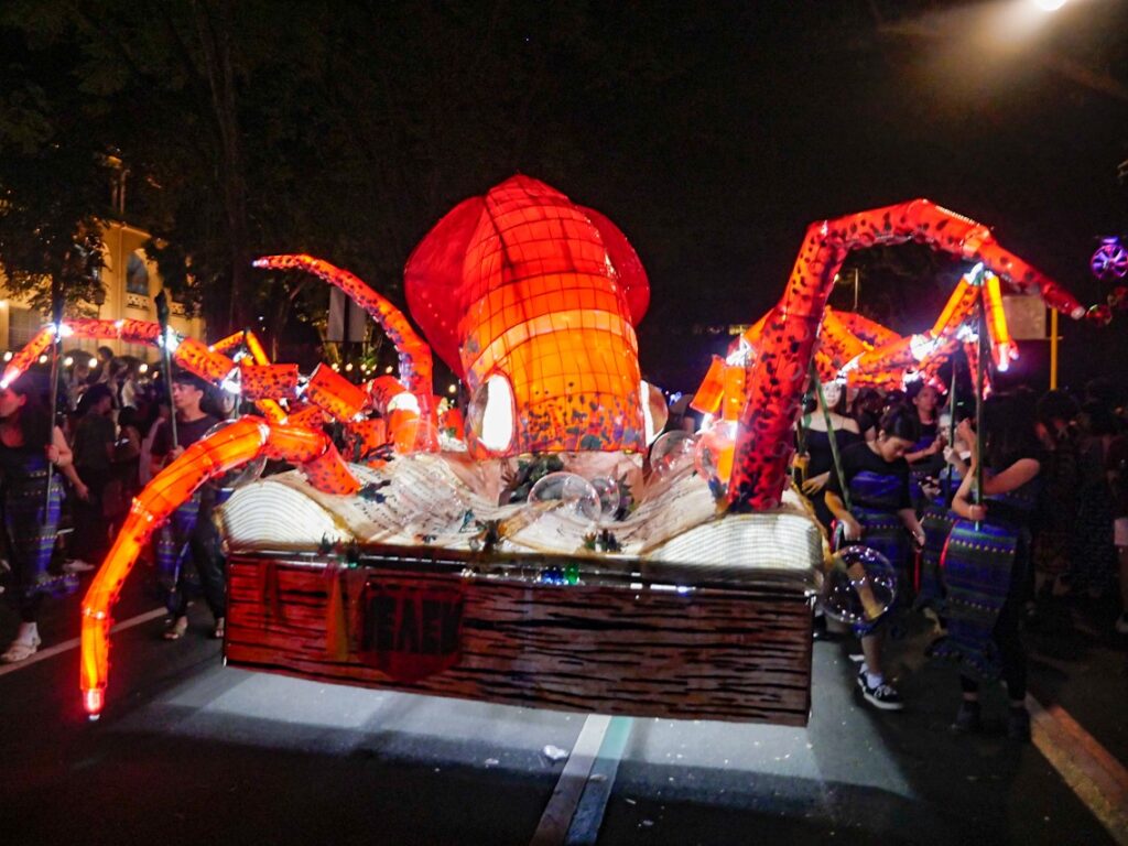 This Red Giant Squid coming out of a newspaper creating an ink blot won first place for the best Christmas Lantern. This lantern display passed through the grounds of the University of the Philippines, Diliman, Quezon City on December 20, 2023. | Photo courtesy of George Buid