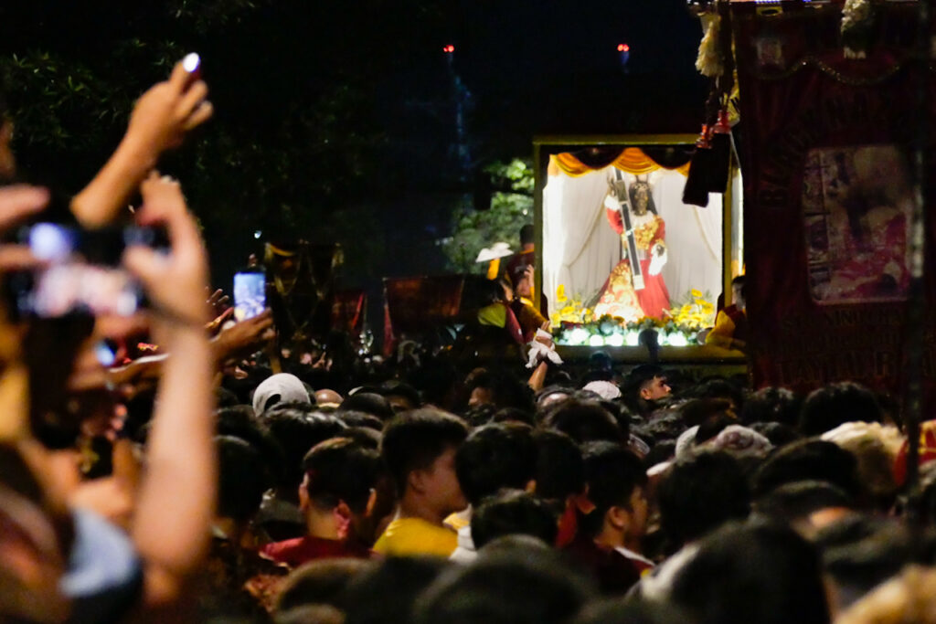 Followers of the Black Nazarene or Black Jesus in the Philippines desperately try to touch the shelter carrying the statue amidst the crowd of two million devotees. | Photo courtesy George Buid