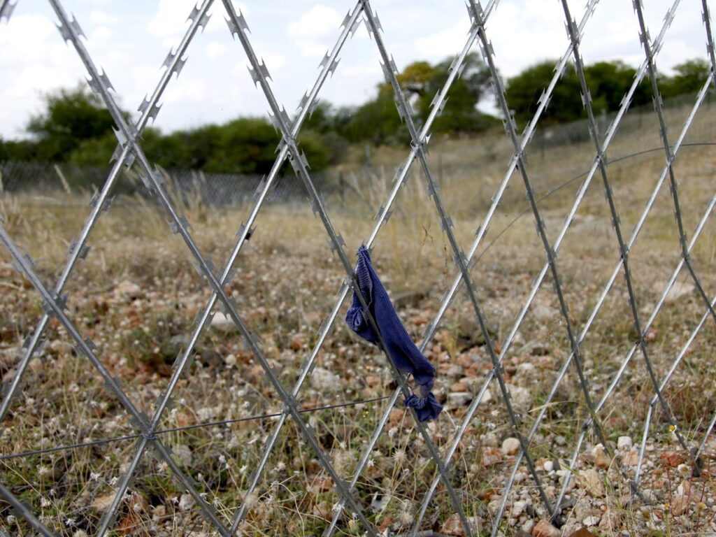 Barbed fencing lines the South Africa - Zimbabwe border. Traveling alone or in small groups, vulnerable children can be attacked, robbed, or even sexually assaulted, according to UK Aid Department of International Development. | Photo courtesy of Simon Davis, UK Aid on Flickr