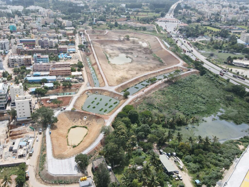 An aerial view of Karnatakas Chikka Thoguru Lake. | Photo courtesy of The goal of India's Lake Man is to rebuild thecountrys lakes in order to produce excess water. | Photo courtesy of The space around one of India's lakes gets cleaned before rejuvination efforts begin. | Photo courtesy of Anand Malligavad