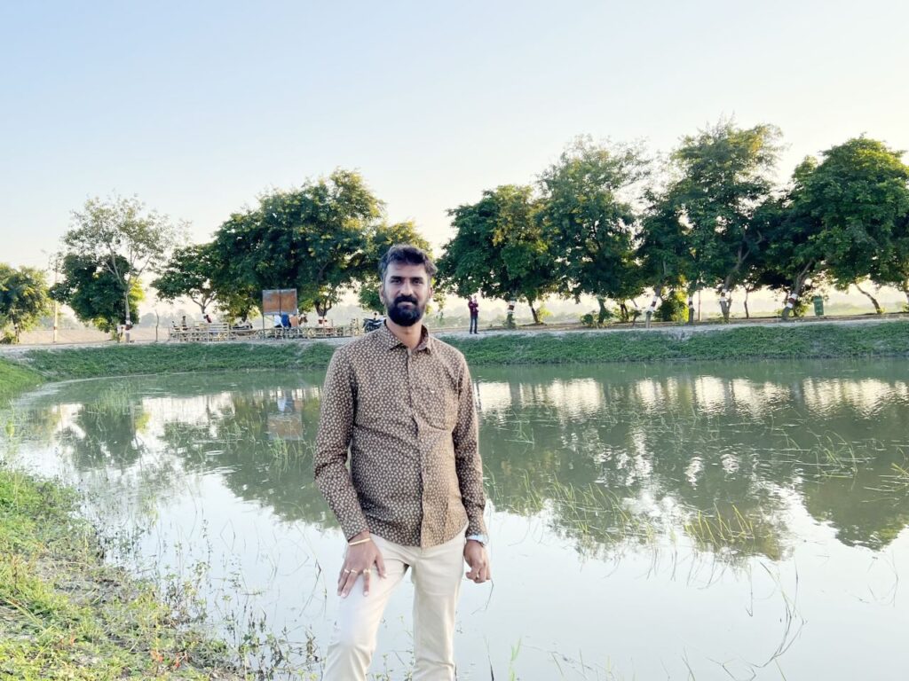 India's Lake Man Anand Malligavad stands in front of one of the lakes his team restored. | Photo courtesy of Anand Malligavad