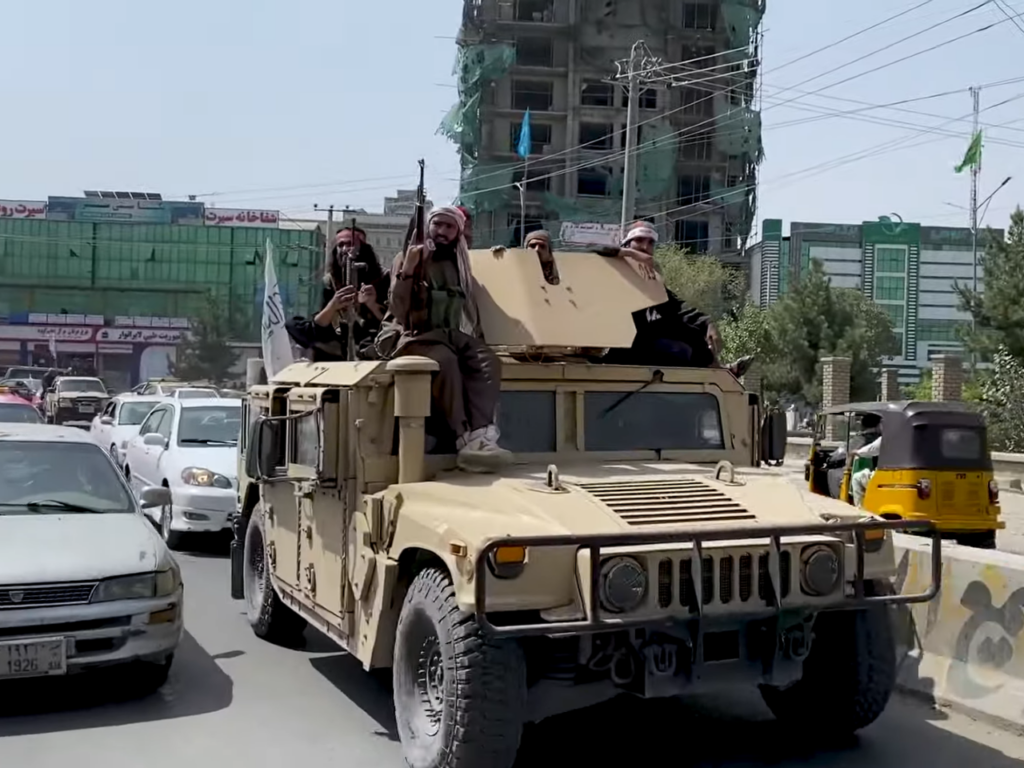Taliban fighters in a captured Humvee after the Fall of Kabul in August 2021 | Photo courtesy of Voice of America News on Wikimedia