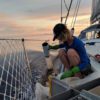 Agustina Besada collects a water sample from the Atlantic on her cross-ocean journey in 2017