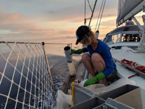Agustina Besada collects a water sample from the Atlantic on her cross-ocean journey in 2017