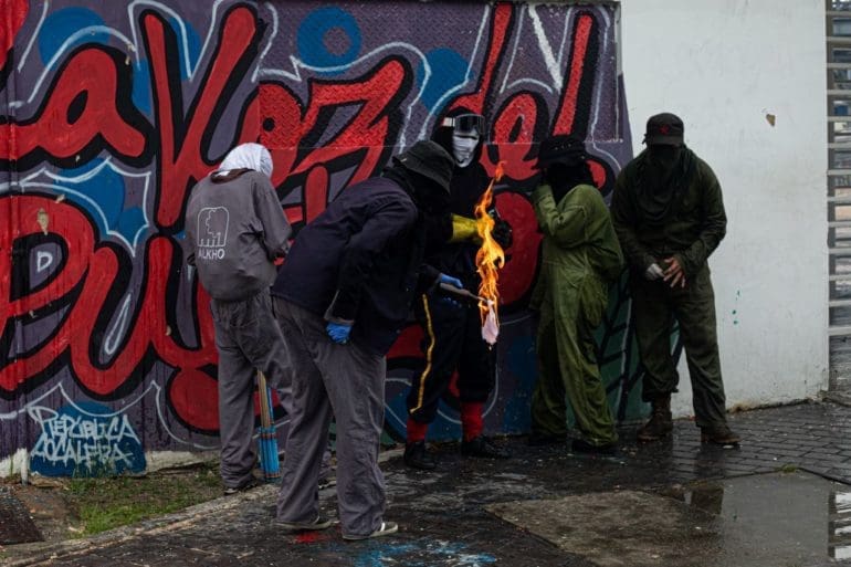 Photographer captures images from the front lines of a life-threatening protest in Colombia leaving one police officer in a coma
