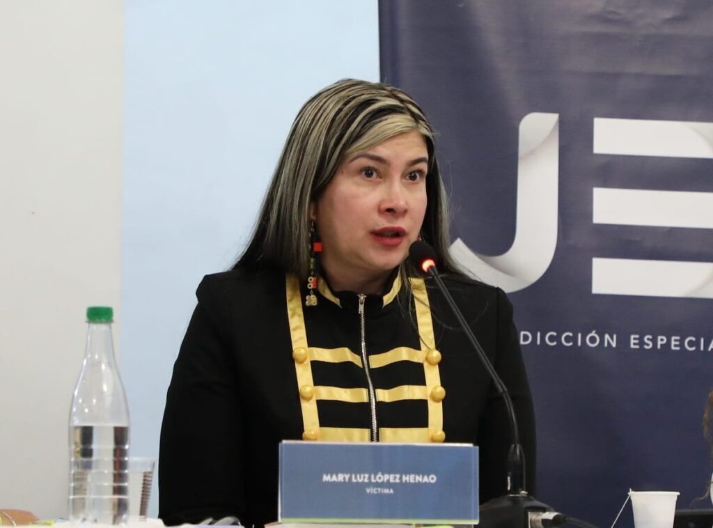 Mary Luz Lopez Henao delivers a powerful speech about her personal journey through the armed conflict, her challenging times including prostitution, and condemning the actions of former guerrilla members. | Photo courtesy of Mary Luz Lopez Henao