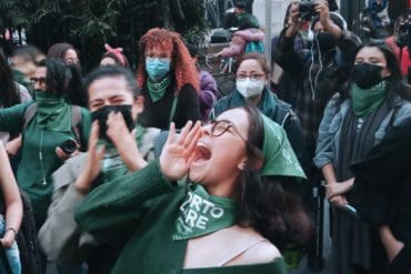 A woman shouts in the street as she celebrates the legalization of abortion in Colombia