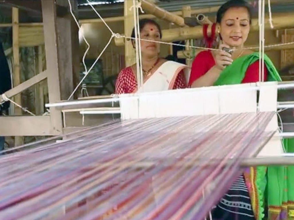 Rupjyoti Saikia Gogoi mixing plastic with cotton threads at her loom in Bocha Gaon village in Assam