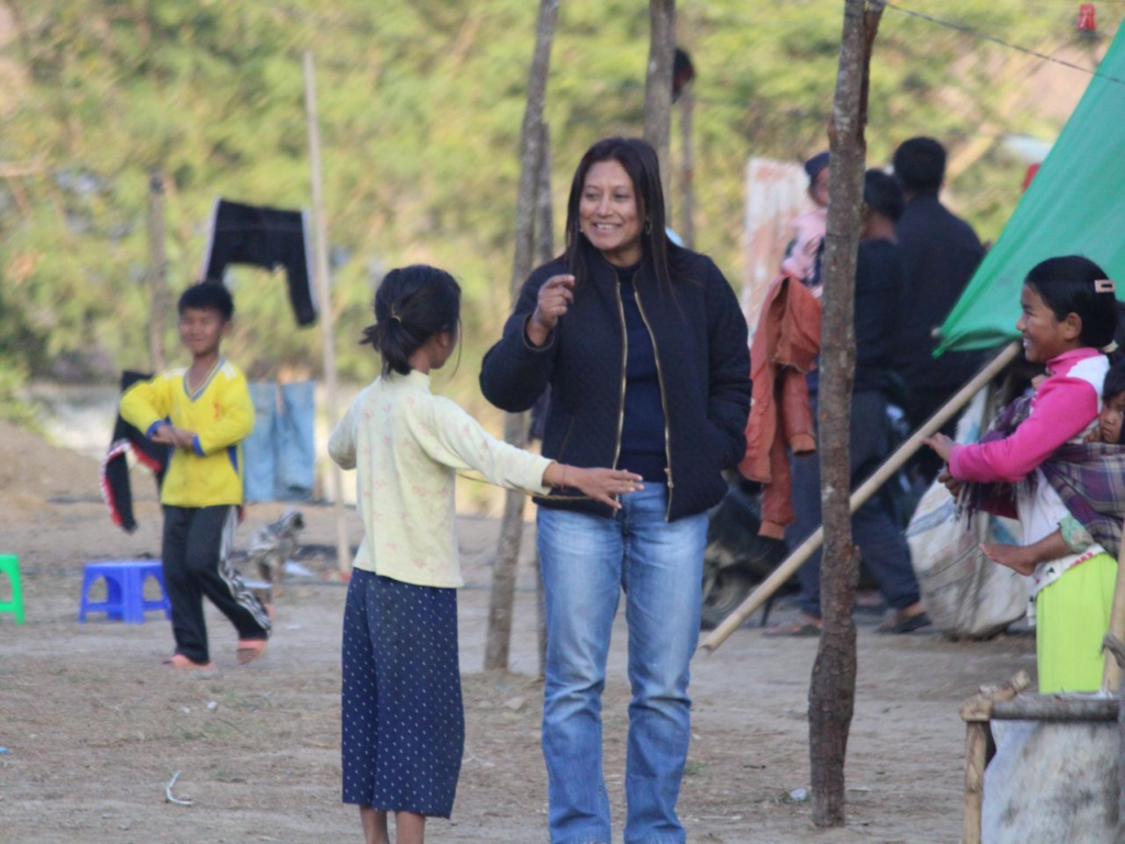 Hasina Kharbhih interacts with children in a community affected by displacement. | Photo courtesy of Hasina Kharbhih.