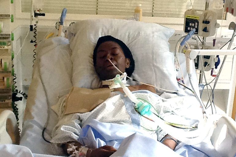 Irene Olumese seen laying in a hospital bed during one of her stays.