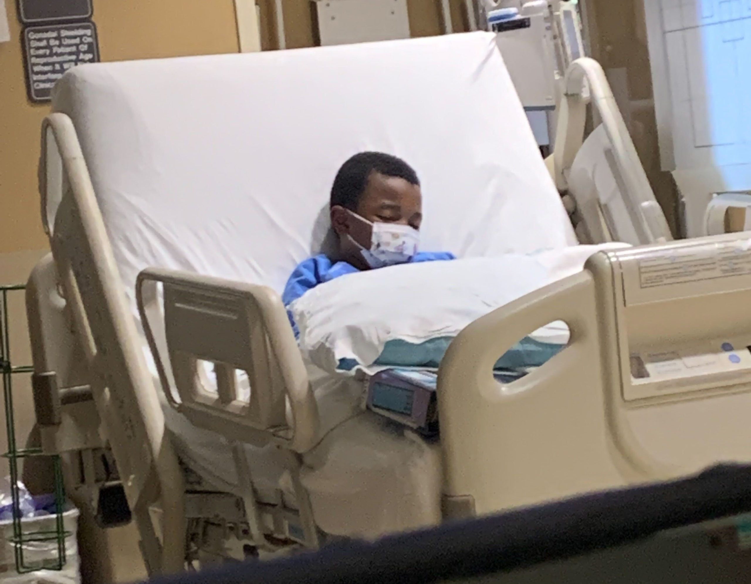 Khrystal Epps' son in his hospital bed. He developed worrying symptoms six weeks after recovering from COVID-19