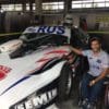Juan poses with his adapted Chevrolet racing car, which he can drive entirely by controls located at the wheel