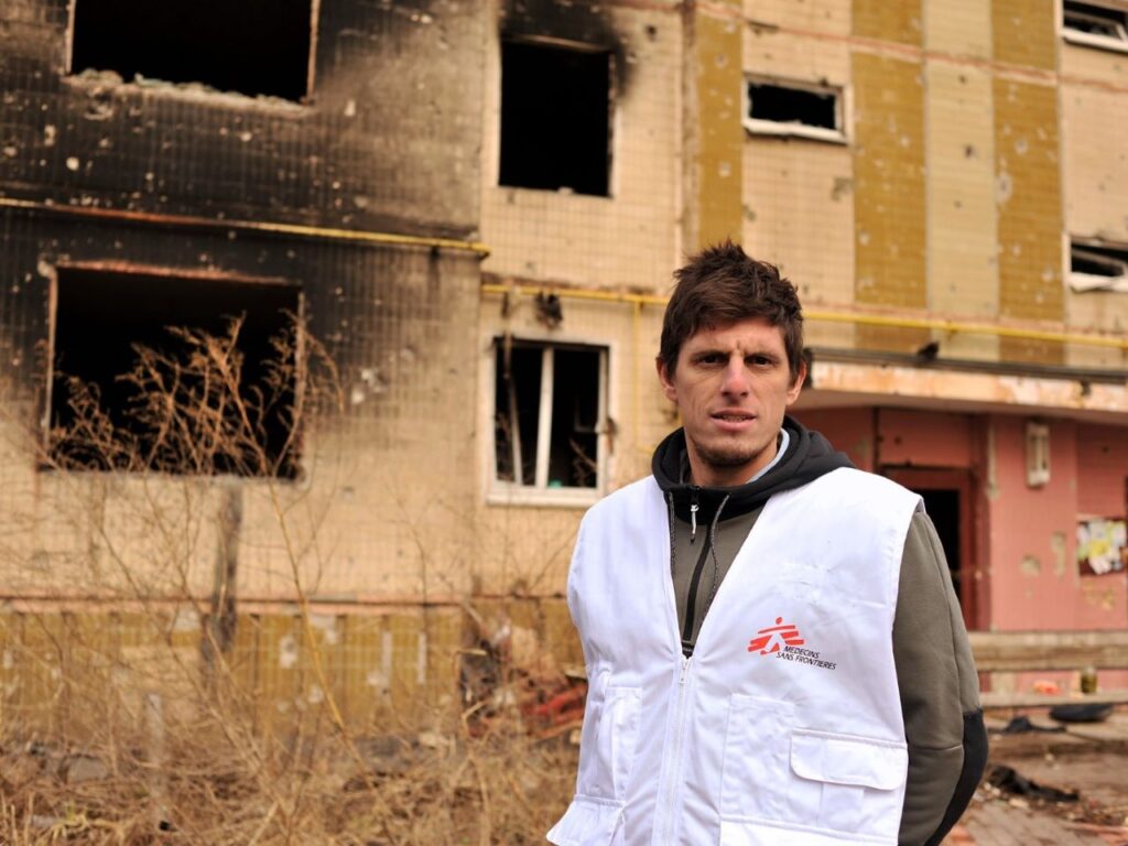 Paulo Milanesio stands outside a destroyed building in Ukraine where he serves as a team leader providing humanitarian medical assistantce. | Photo courtesy of Doctors Without Borders