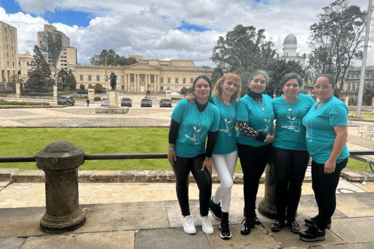 Leaders of Mujeres Libres Colombia stand in front of the Senate of the Republic