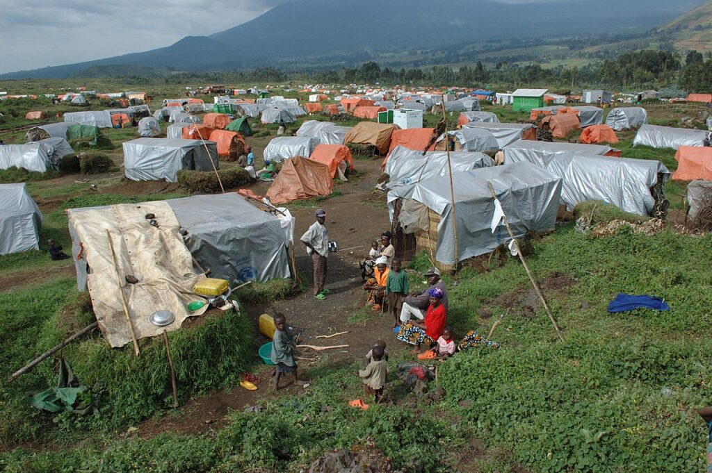 Families gather inside a temporary displacement camp in Africa.