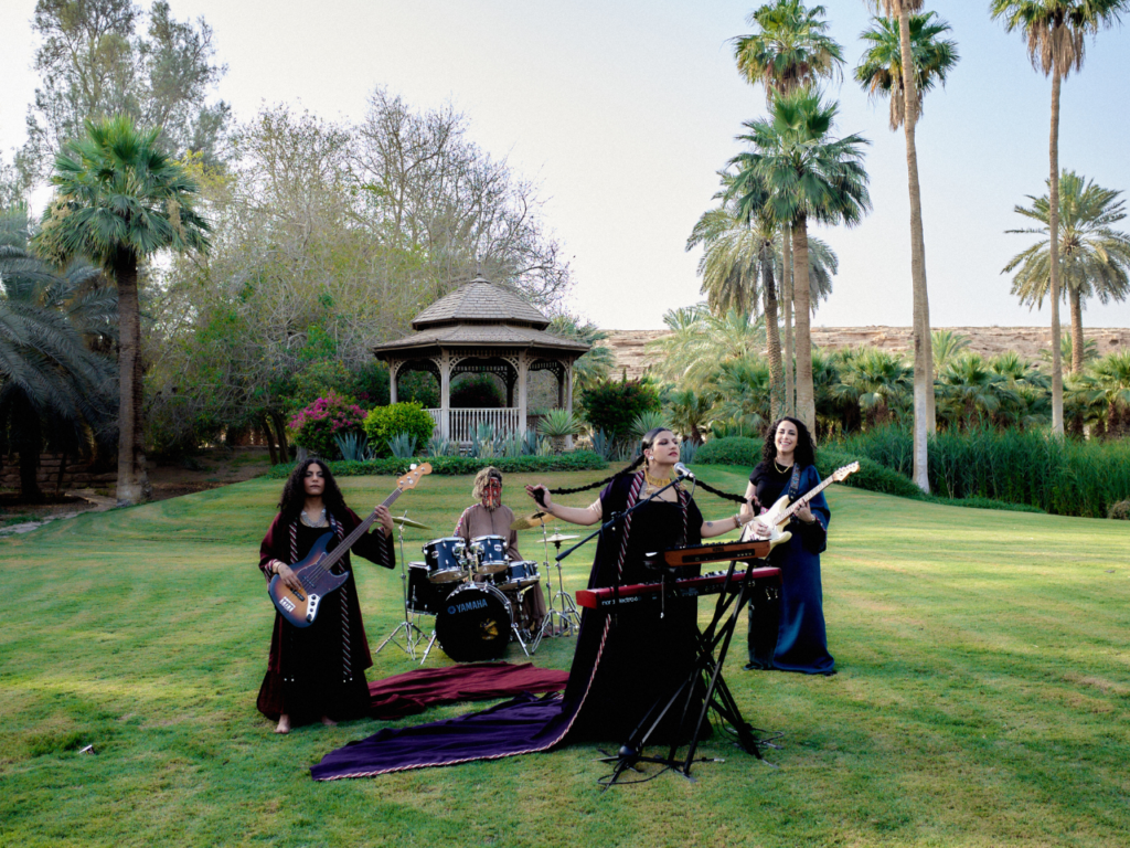 Saudi Arabian all-female rock band Seera performs in an outdoor setting surrounded by lush greenery. | Photo courtesy of Raman.3000