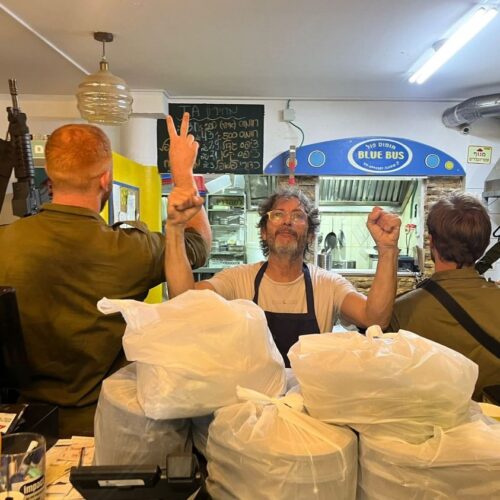 Sergio Helman owner of Blue Bus restaurant prepares food for Israeli soldiers