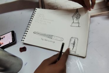 One of Professor Yashwant Dattatreya Pitkar's students sketches a fountain pen they designed