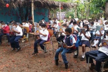 Students at the Mercedes Calderón school taking classes on land lent for the last 11 years