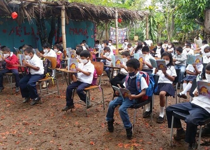 Students at the Mercedes Calderón school taking classes on land lent for the last 11 years