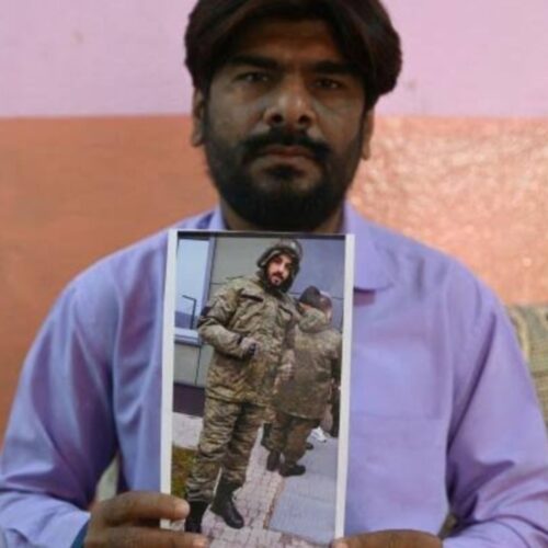 Mohammed Imran with a photo of his younger brother Mohammed Asfan who was killed in Russia