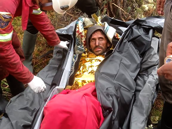 The rescue team wraps Jeshua in a thermal blanket shortly after finding him