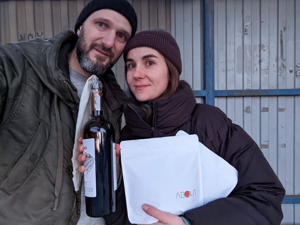 Svitlana Lytvak and her partner Alex, co-owners of About Coffee in Cherkasy, Ukraine, hold a Molotov cocktail and a bag of coffee beans