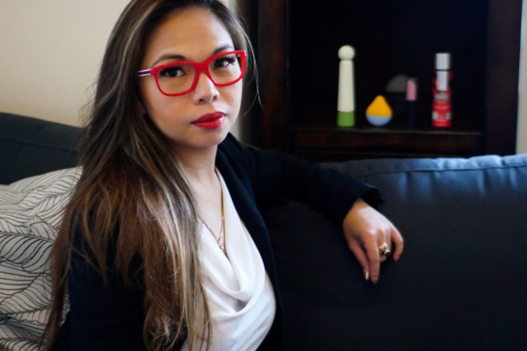 Dr. Rica Cruz, founder of Unprude, with the brand's products in the background