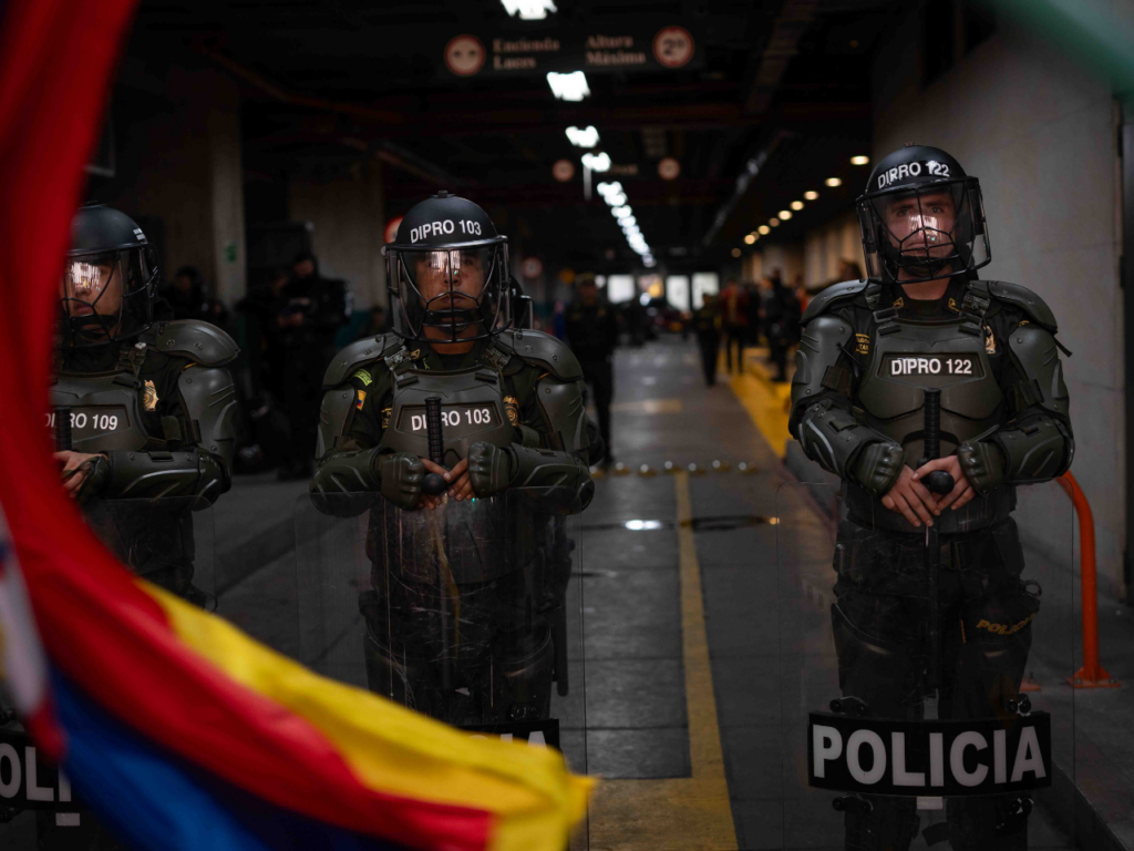 Riot police in full gear stand at the ready in a subway station in Colombia. | Photo courtesy of Camilo Vargas