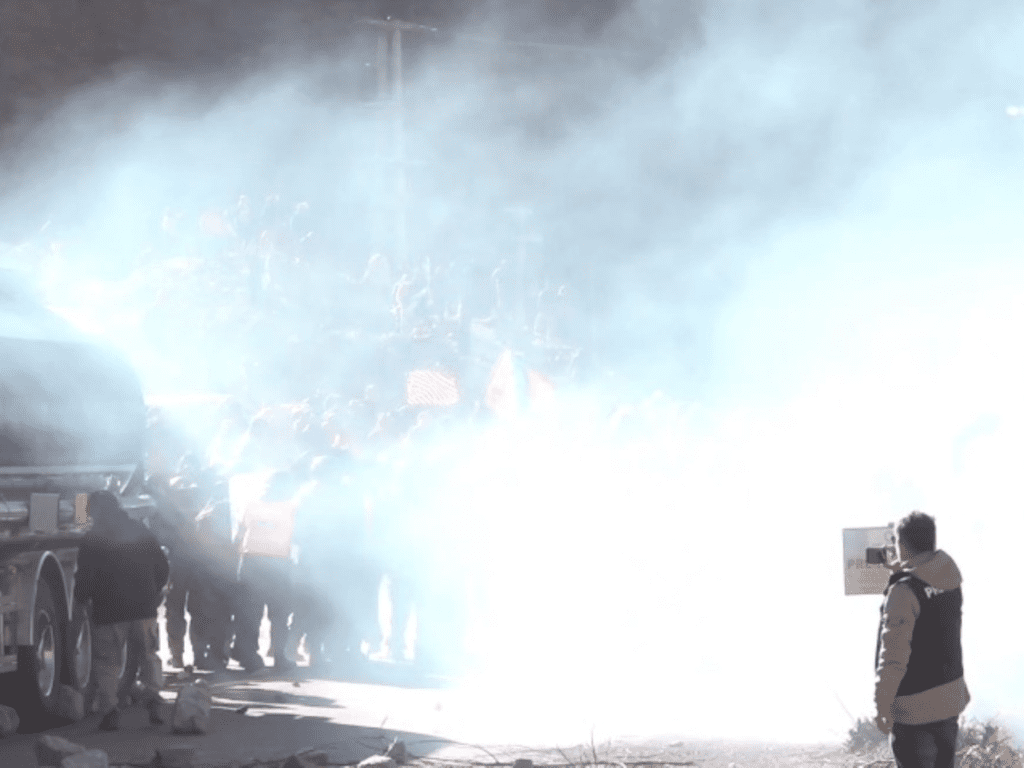 Police release tear gas during a peaceful protest by teachers, indigenous people, and labor unions.