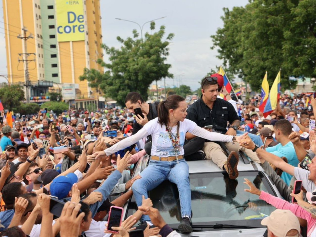 María Corina Machado reaches out to supporters during a protest, symbolizing the fight for democracy in Venezuela. | Photo courtesy of Luis Gonzalo Perez.