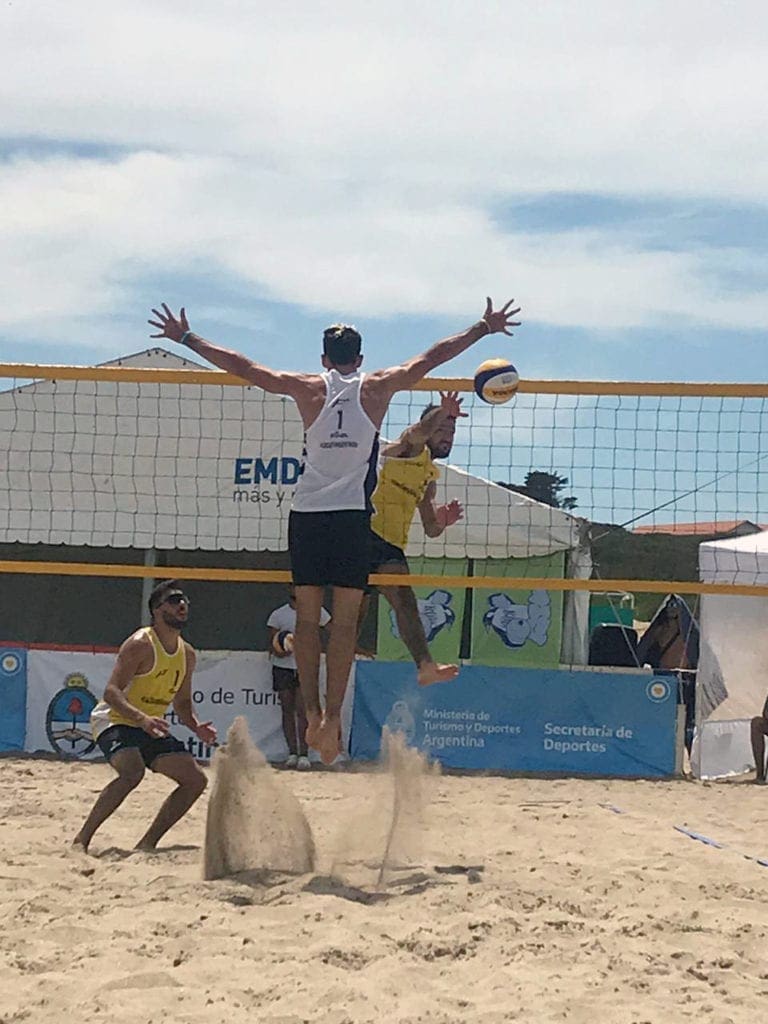 Mauro Zelayeta jumps high in the air attempting to stop a spike.