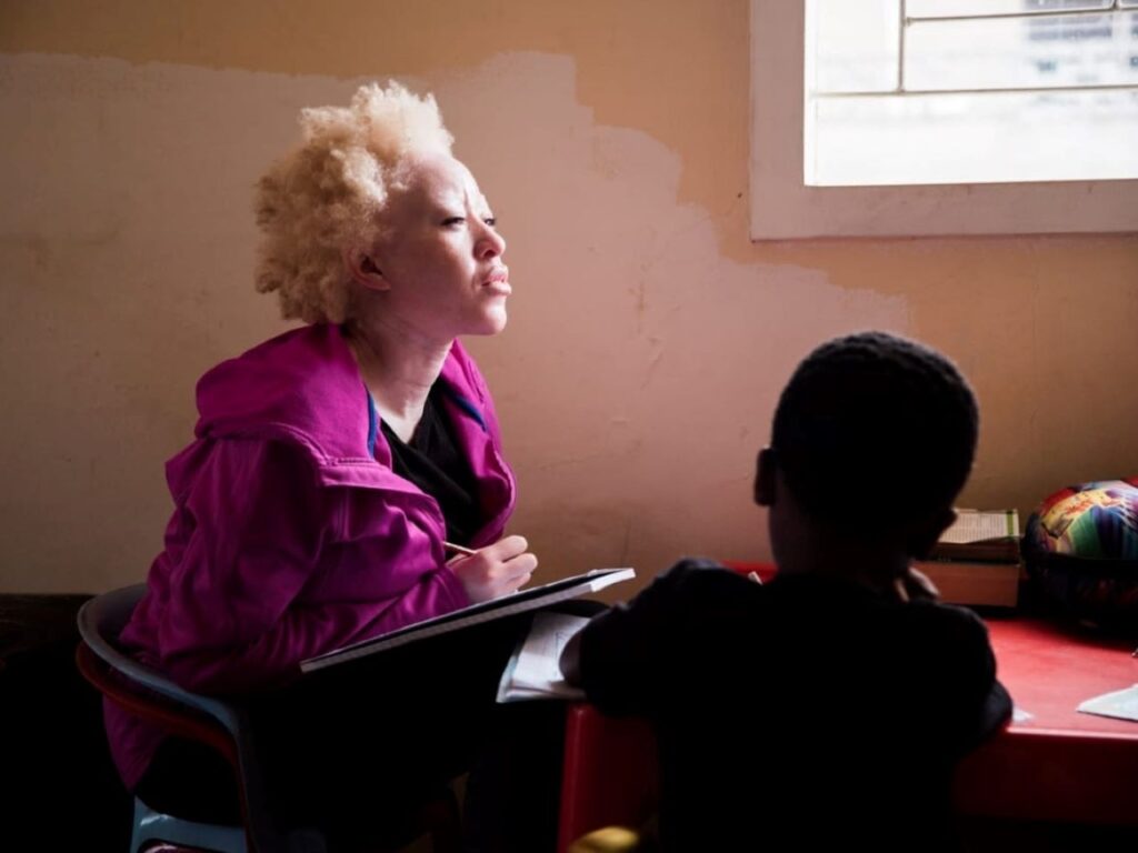 Regina Mary Ndlovu, who suffered from severe discrimination, sexual abuse, and illiteracy due to her albinism, now uses her voice to advocate for the rights of albino individuals and empower children. | Photo courtesy of Regina Mary Ndlovu