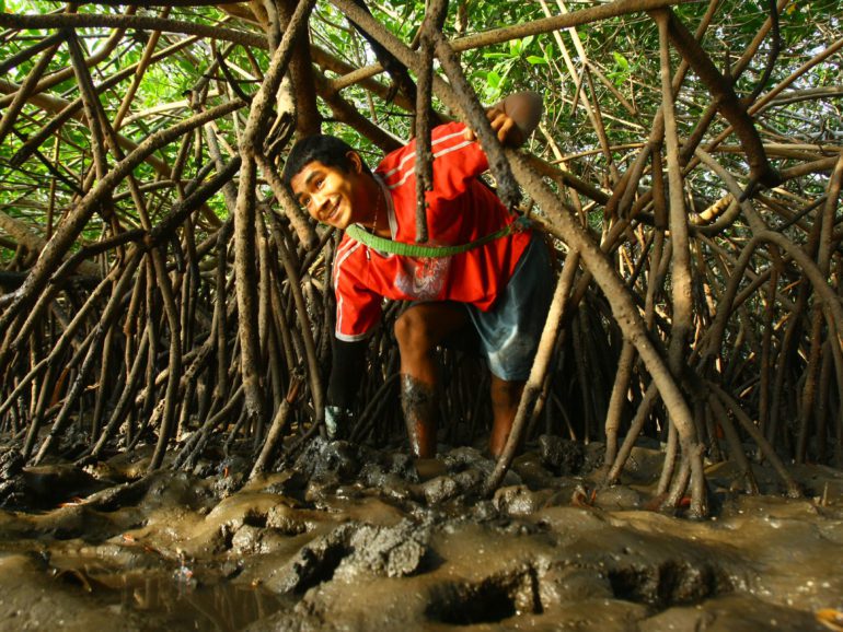 Married at 15, he collects blood clams for $5 a day to make ends meet