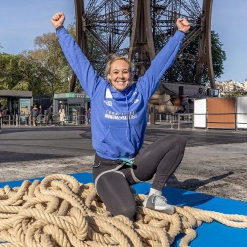 France's Anouk Garnier celebrates the new world record set by climbing 110 meters of the Eiffel Tower on a rope in Paris on April 10, 2024.
