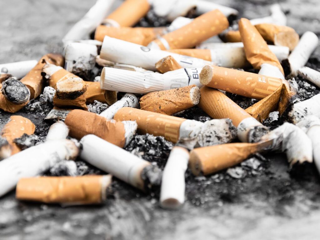 Cigarette butts represent the largest plastic pollutant in the world and seep tons of toxic chemicals into the earth. | Photo courtesy of Pawel Czerwinski on Unsplash