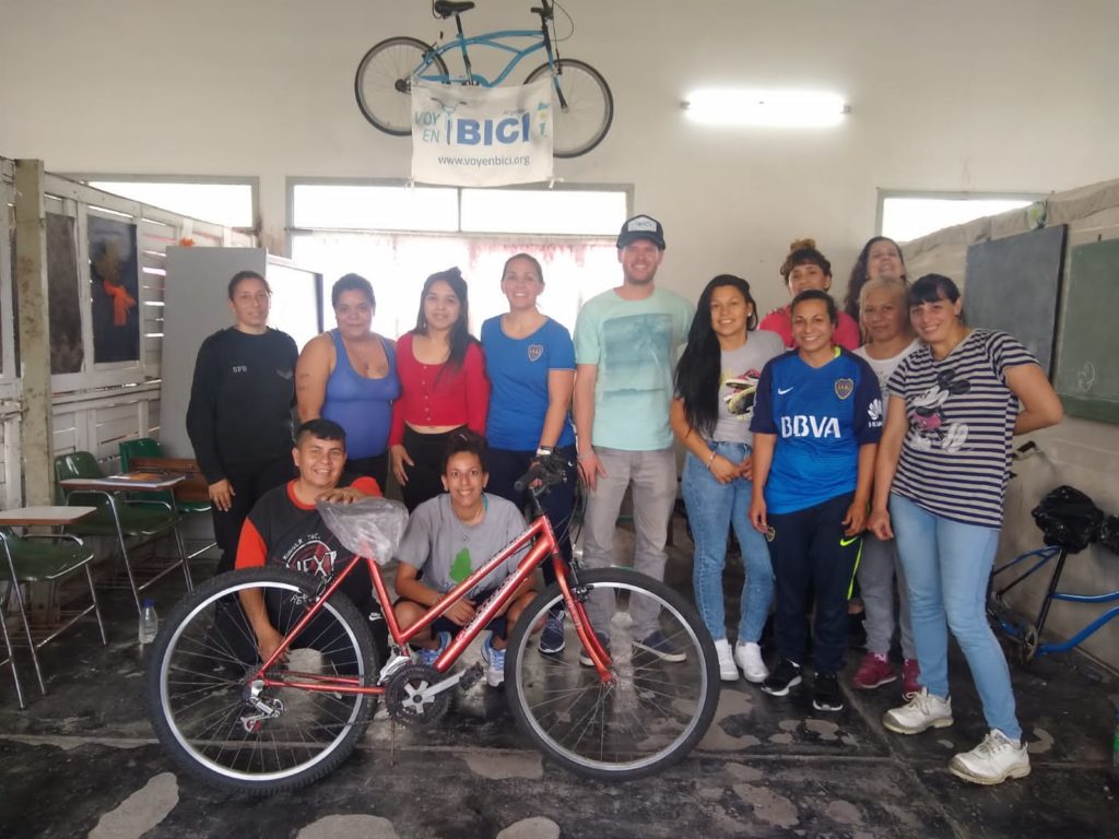 The team delivers bicycles in a neighborhood in Argentina, bicycles repaired and refurbished by women in the prison