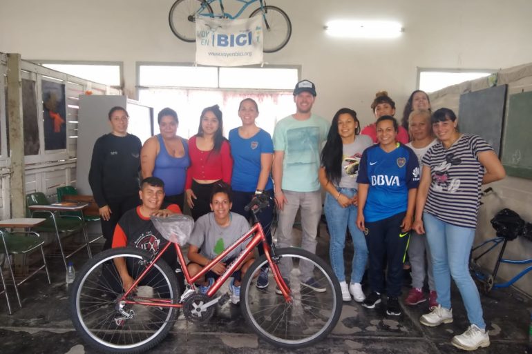 The team delivers bicycles in a neighborhood in Argentina, bicycles repaired and refurbished by women in the prison